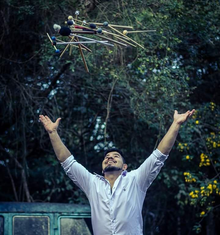 Renan with arms raised outdoors