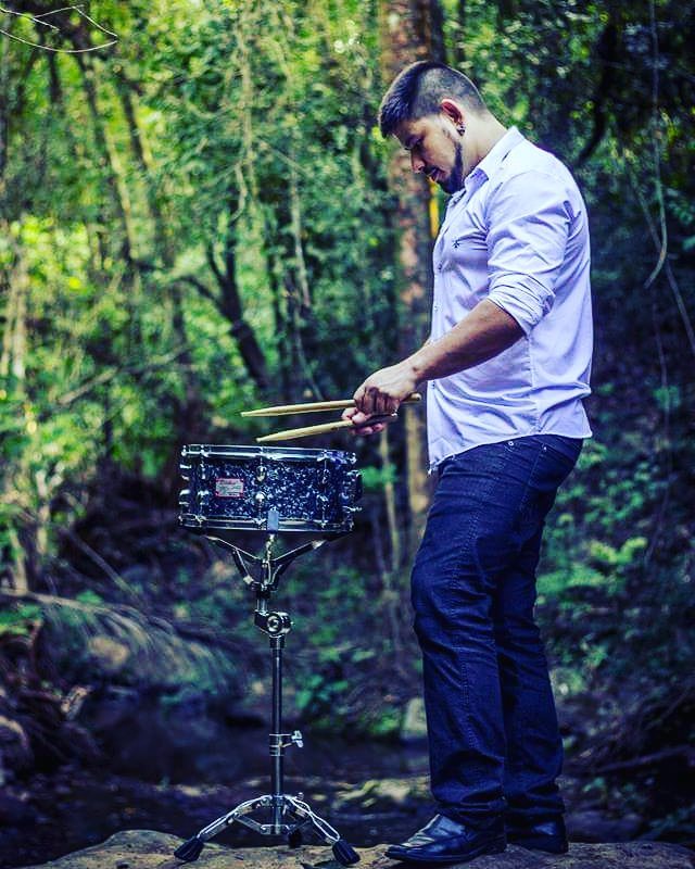 Renan playing snare drum outdoors